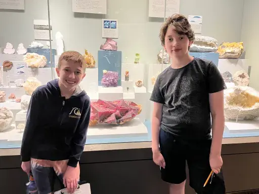 Two students are excited on a trip to the Minerals & Gems Exhibit.