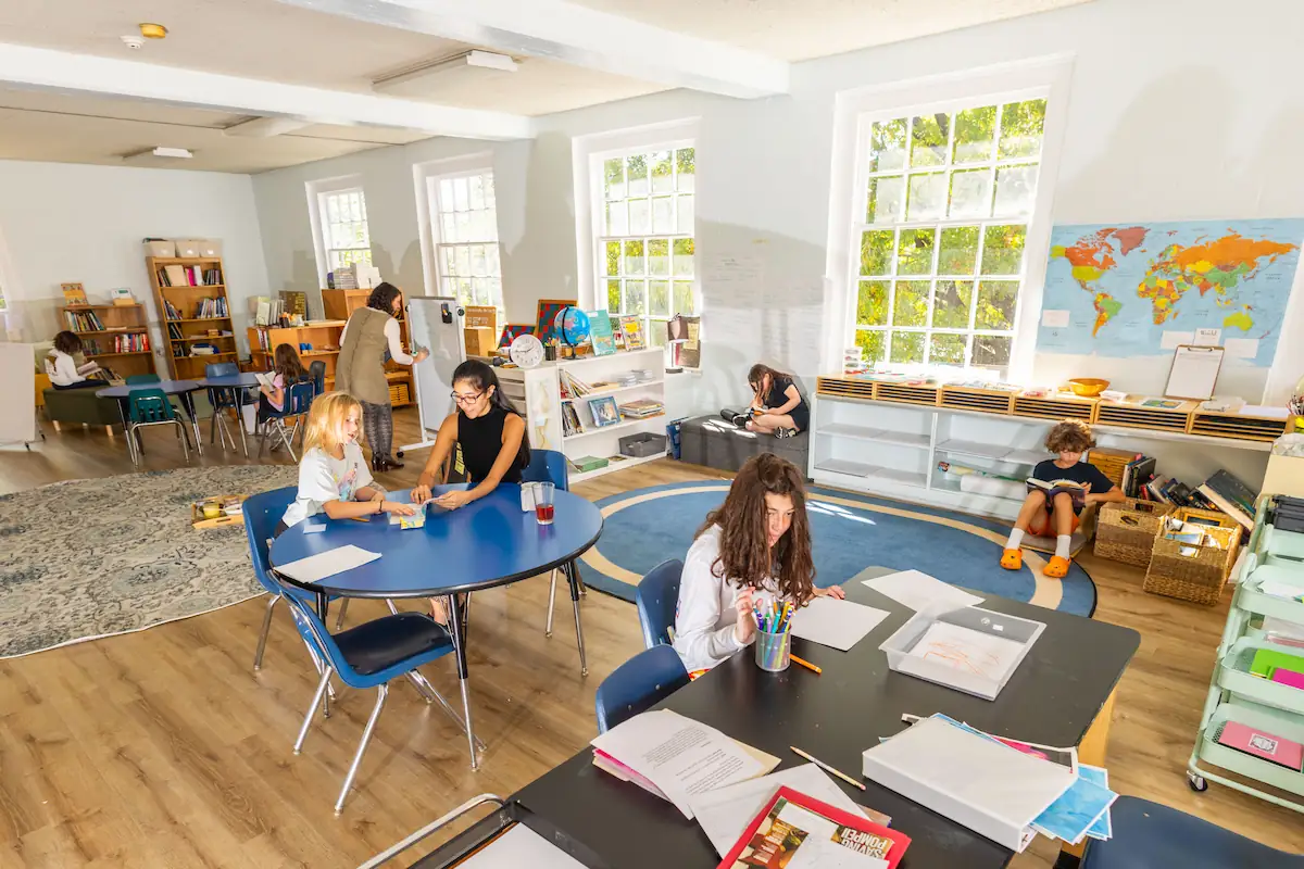 Students are in different parts of the classroom working on their own activities