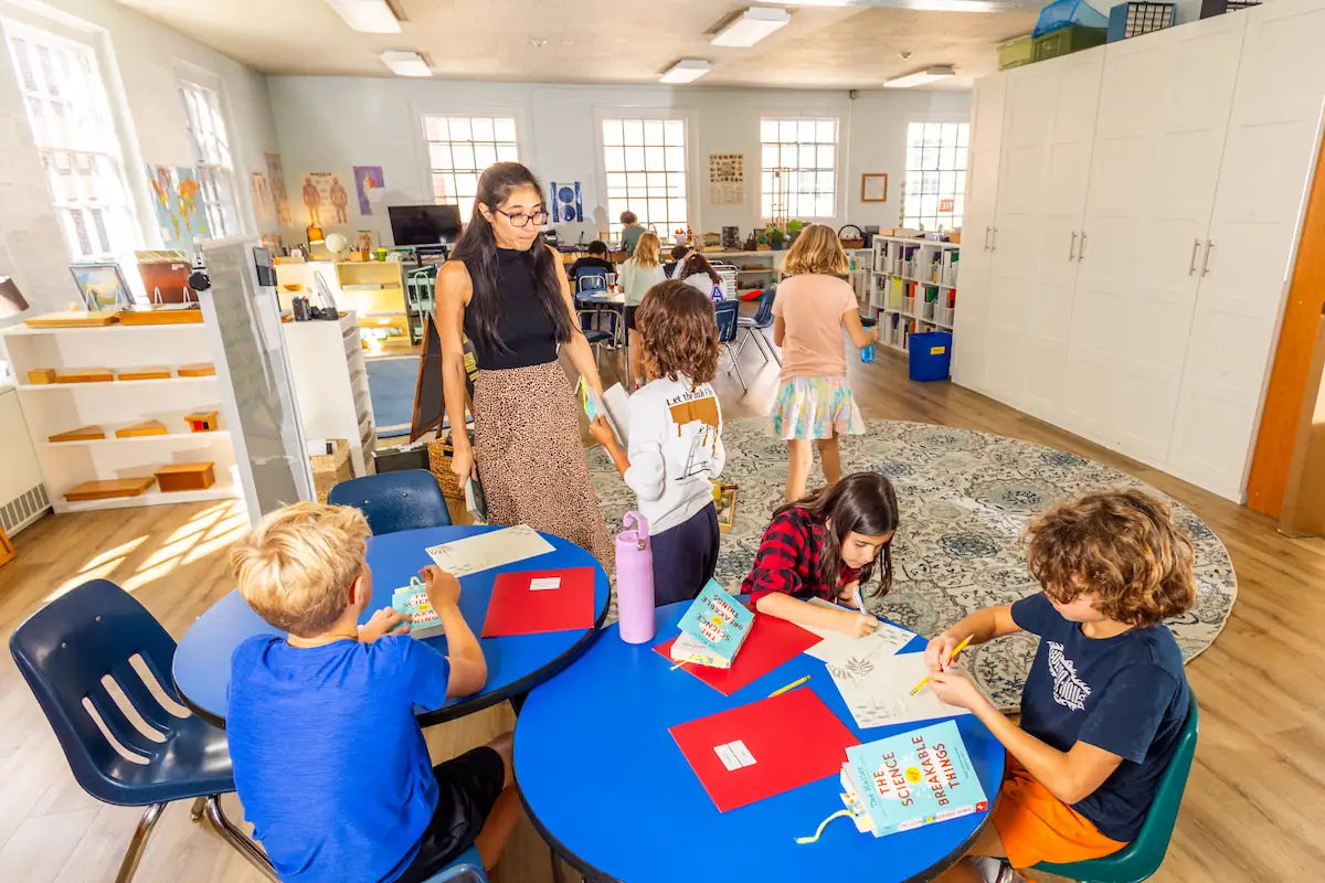Students are in different parts of the classroom immersed in their projects
