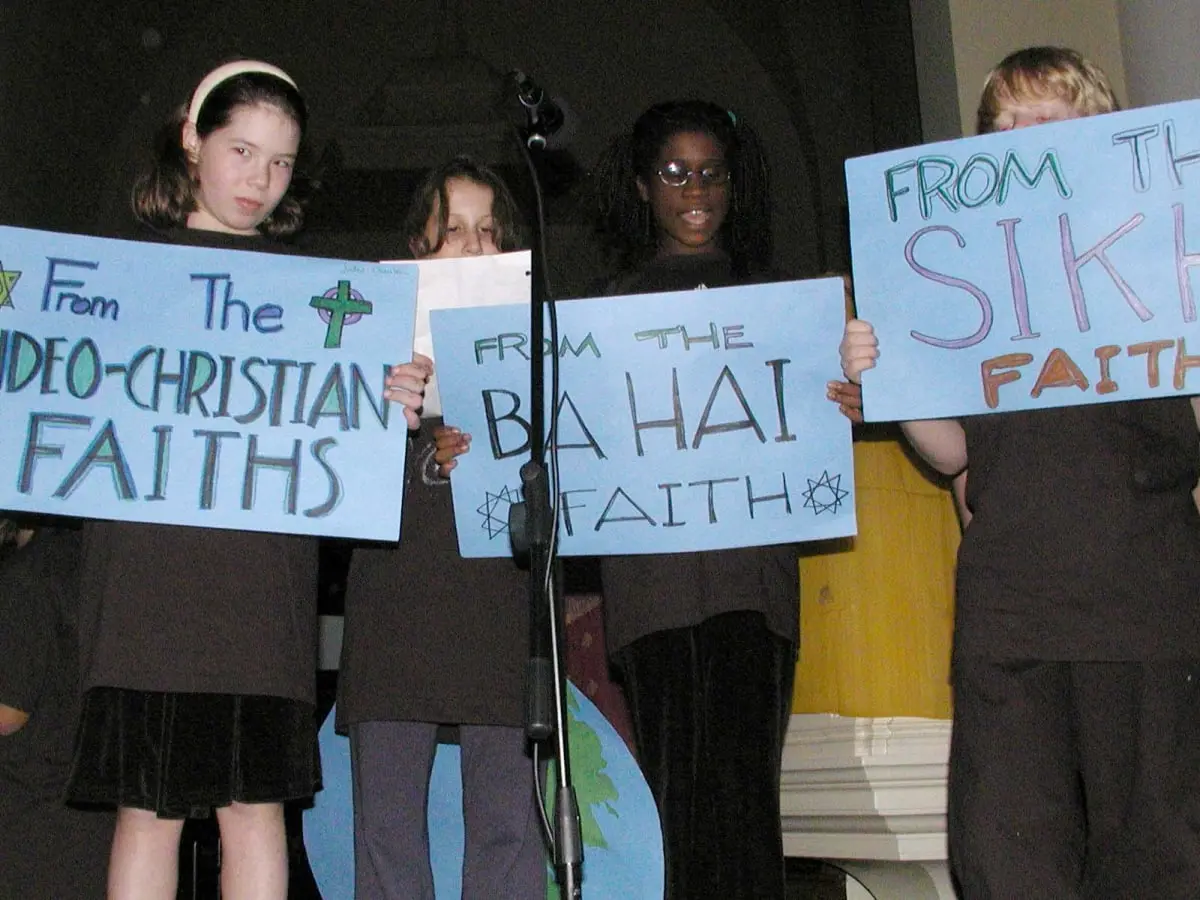 Photo of students holding up hand-drawn signs