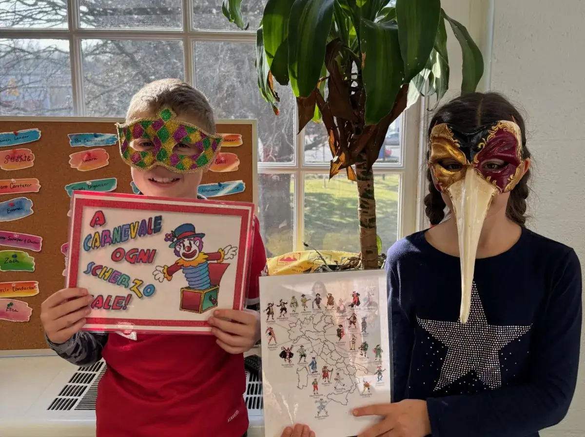 Students are posing wearing Carnival masks.