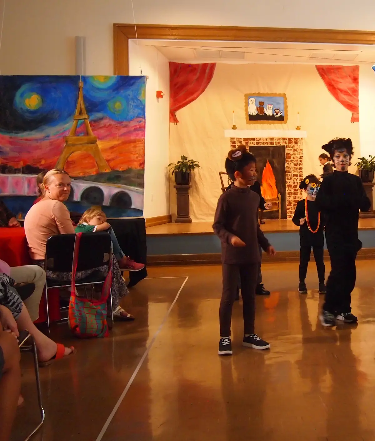 Students are performing with animal face paint and ears.