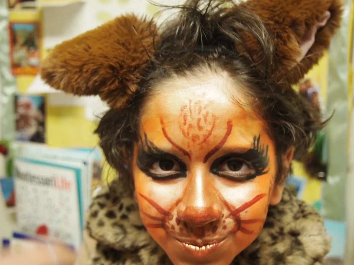 A student has her face painted like an animal