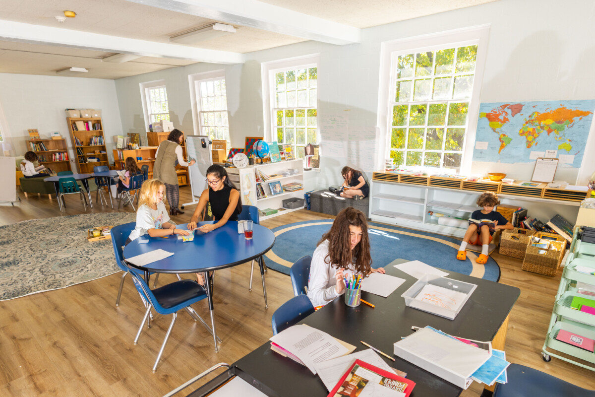Student sit and work on independent work throughout the classroom