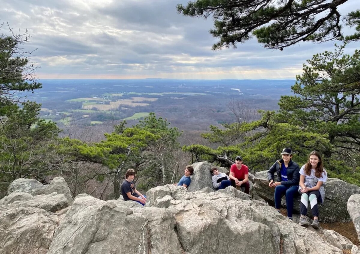 Children facing camera; behind them is the landscape from the top of Sugarloaf Mountain. 